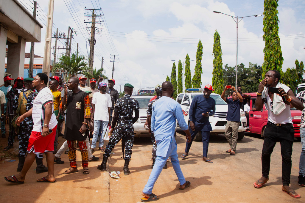 People protest during the launch of a new, state backed, Museum of West African Arts in Benin City, Nigeria, Sunday, Nov. 9, 2025. (AP Photo/Akpobasaha Oghenemaro Godspower )