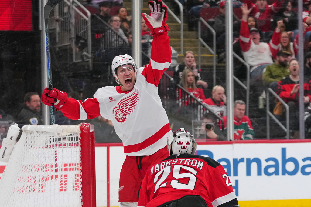 Detroit Red Wings' Dominik Shine (65) celebrates after shooting the puck past New Jersey Devils goaltender Jacob Markstrom (25) for a goal during the third period of an NHL hockey game Sunday, March 8, 2026, in Newark, N.J. (AP Photo/Frank Franklin II)