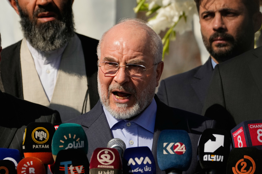 Iranian Parliament Speaker Mohammad Baqer Qalibaf addresses attendees at the site near Baghdad International Airport where Iranian military commander Qassem Soleimani was killed in a U.S. drone strike, in Baghdad, Iraq, Wednesday, Aug. 19, 2026.(AP Photo/Hadi Mizban)