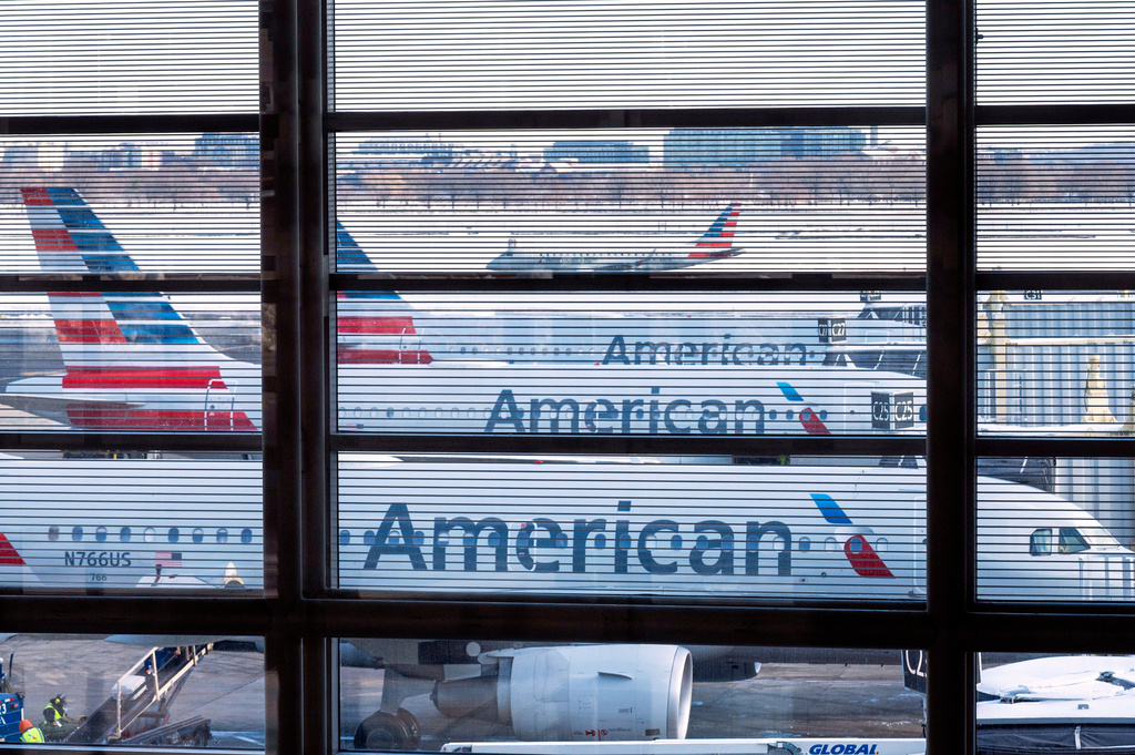 FILE - American Airlines passenger planes are seen at gates at Ronald Reagan Washington National Airport, Jan. 29, 2026 in Arlington, Va. (AP Photo/Cliff Owen, File)