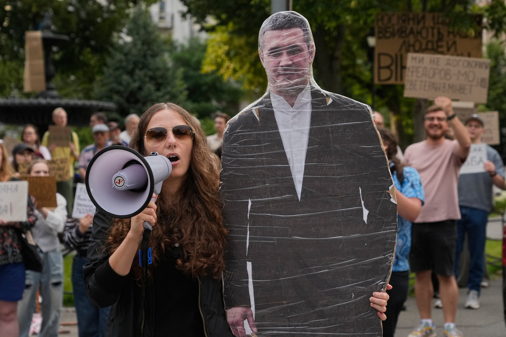 Demonstrators hold a photo of former Defense Minister Mykhailo Fedorov during a rally to denounce President Volodymyr Zelenskyy's decision to dismiss Fedorov after six months in the post, in Kyiv, Ukraine, Friday, July 24, 2026. (AP Photo/Efrem Lukatsky)
