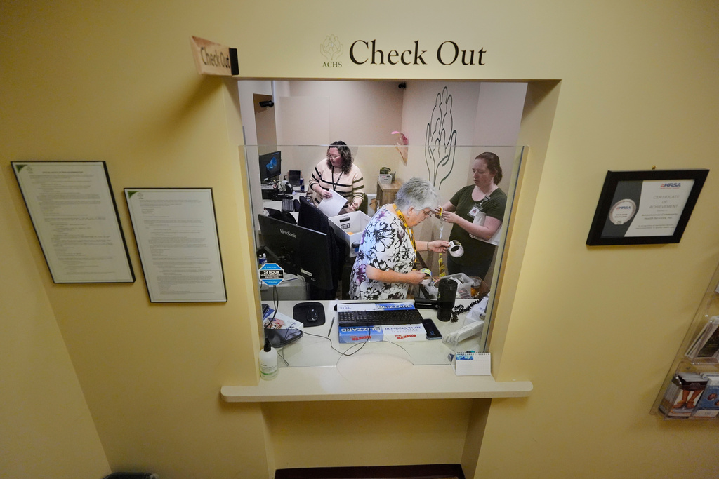 Employees at Ammonoosuc Community Health Services pack up the reception office as the clinic closes for good, Thursday, Oct. 23, 2025, in Franconia, N.H. (AP Photo/Robert F. Bukaty)