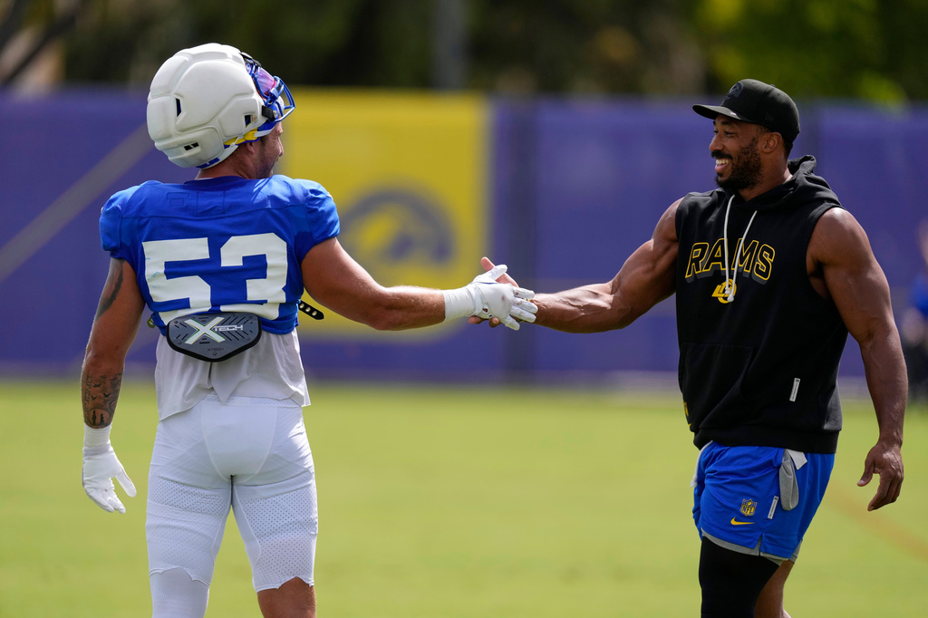 Los Angeles Rams linebacker Nate Landman, left, shakes hands with defensive end Myles Garrett during an NFL football joint practice against the Dallas Cowboys, Tuesday, Aug. 11, 2026, in Los Angeles. (AP Photo/Mark J. Terrill)