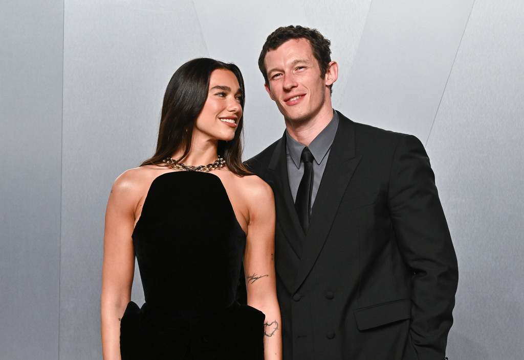 FILE - Dua Lipa, left, and Callum Turner arrive at the Vanity Fair Oscar Party on Sunday, March 15, 2026, at the Los Angeles County Museum of Art in Los Angeles. (Photo by Evan Agostini/Invision/AP, File)