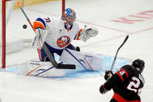 New York Islanders goaltender Ilya Sorokin (30) deflects a shot from Ottawa Senators center Dylan Cozens (24) during the first period of an NHL hockey game in Ottawa, Ontario, Saturday, Oct. 18, 2025. (Adrian Wyld/The Canadian Press via AP) New York Islanders goaltender Ilya Sorokin (30) deflects a shot from Ottawa Senators center Dylan Cozens (24) during the first period of an NHL hockey game in Ottawa, Ontario, Saturday, Oct. 18, 2025. (Adrian Wyld/The Canadian Press via AP)