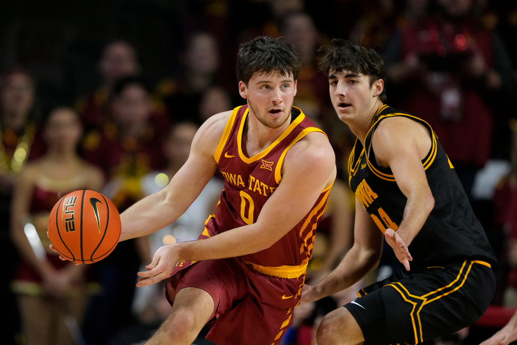 Iowa State guard Nate Heise (0) drives around Iowa guard Tate Sage during the first half of an NCAA college basketball game, Thursday, Dec. 11, 2025, in Ames, Iowa. (AP Photo/Charlie Neibergall)