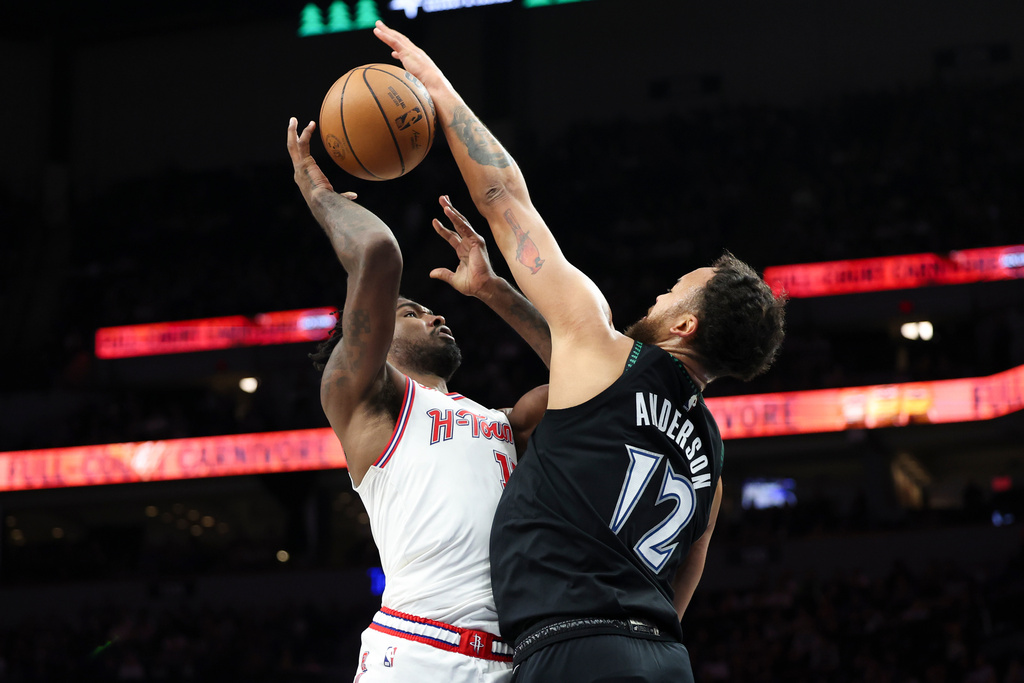 Houston Rockets forward Tari Eason (17) shoots while Minnesota Timberwolves forward Kyle Anderson (12) blocks during the first half of an NBA basketball game, Wednesday, March 25, 2026, in Minneapolis. (AP Photo/Ellen Schmidt)
