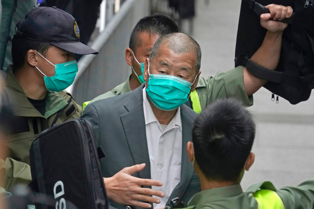 FILE - Democracy advocate Jimmy Lai, center, leaves the Hong Kong's Court of Final Appeal in Hong Kong on Feb. 9, 2021. (AP Photo/Kin Cheung, File)