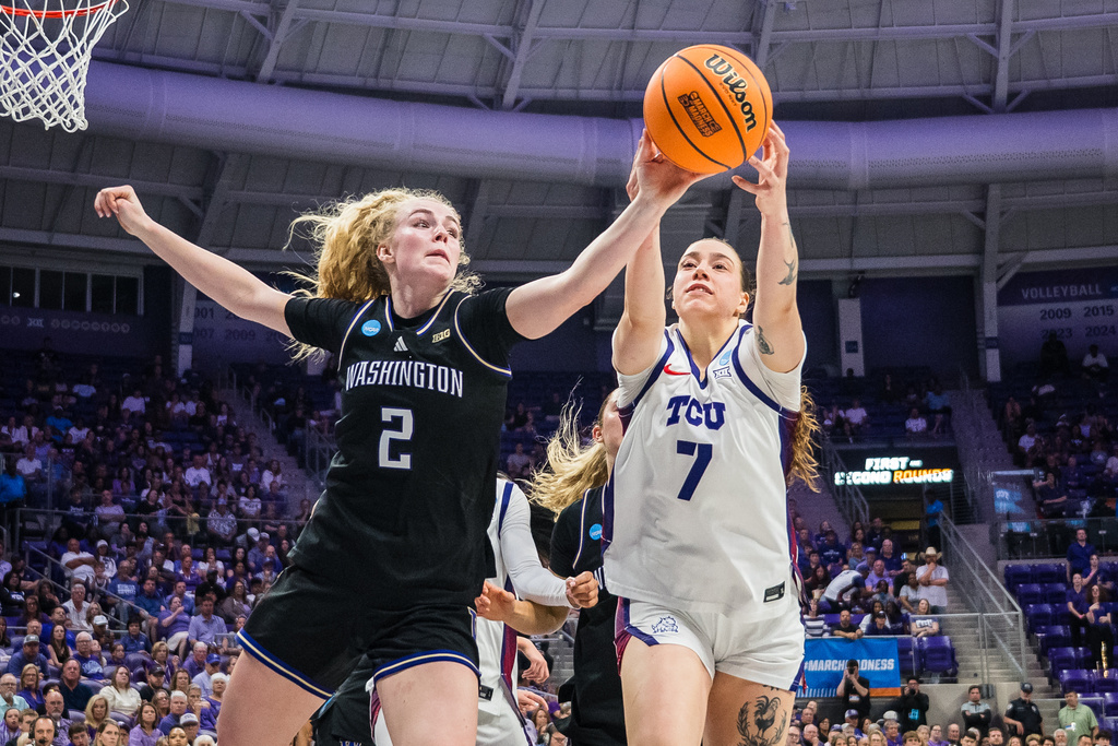 Washington guard Avery Howell (2) and TCU forward Marta Suárez (7) go for a rebound during the first half in the second round of the NCAA college basketball tournament Sunday, March 22, 2026, Fort Worth, Texas. (AP Photo/Jessica Tobias)