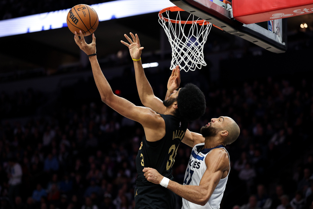 Cleveland Cavaliers center Jarrett Allen, left, goes up for a shot as Minnesota Timberwolves center Rudy Gobert (27) defends during the first half of an NBA basketball game, Thursday, Jan. 8, 2026, in Minneapolis. (AP Photo/Matt Krohn)