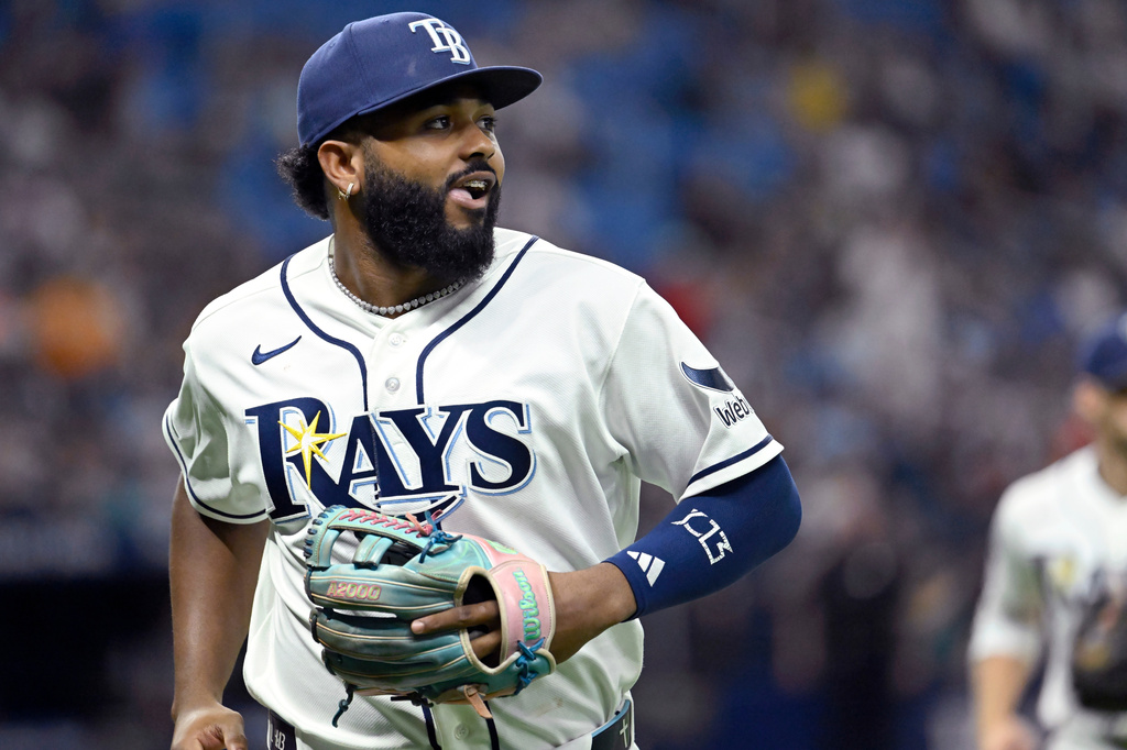 Tampa Bay Rays third baseman Junior Caminero watches a replay on his way to the dugout after the final out of the top of the seventh inning of a baseball game against the Seattle Mariners, Friday, July 10, 2026, in St. Petersburg, Fla. (AP Photo/Jason Behnken)