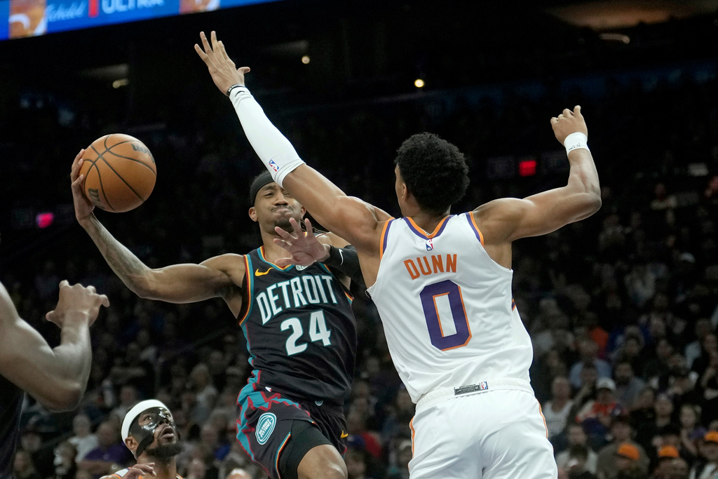 Detroit Pistons guard Daniss Jenkins (24) tries to drive past Phoenix Suns forward Ryan Dunn (0) during the first half of an NBA basketball game Thursday, Jan. 29, 2026, in Phoenix. (AP Photo/Ross D. Franklin)
