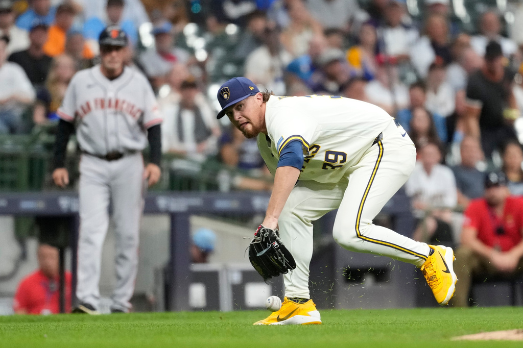 Milwaukee Brewers' Chad Patrick is unable to field a bunt hit by San Francisco Giants' Jung Hoo Lee during the eighth inning of a baseball game Wednesday, June 3, 2026, in Milwaukee. (AP Photo/Aaron Gash)