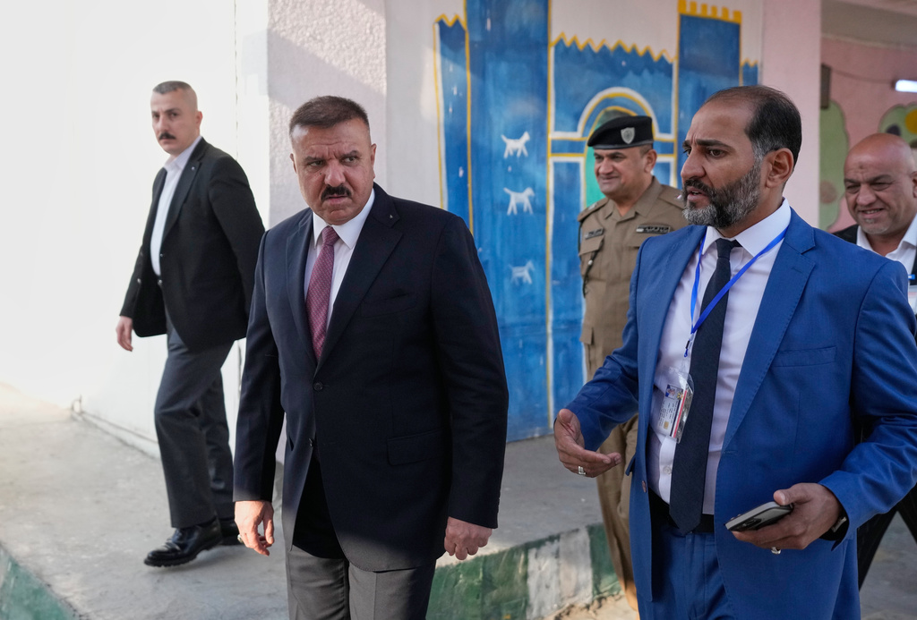 Iraq's Interior Minister Abdul Amir al-Shammari, center, visits one of the polling centers during a special voting session ahead of Tuesday's parliamentary election in Baghdad, Iraq, Sunday, Nov. 9, 2025. (AP Photo/Hadi Mizban)