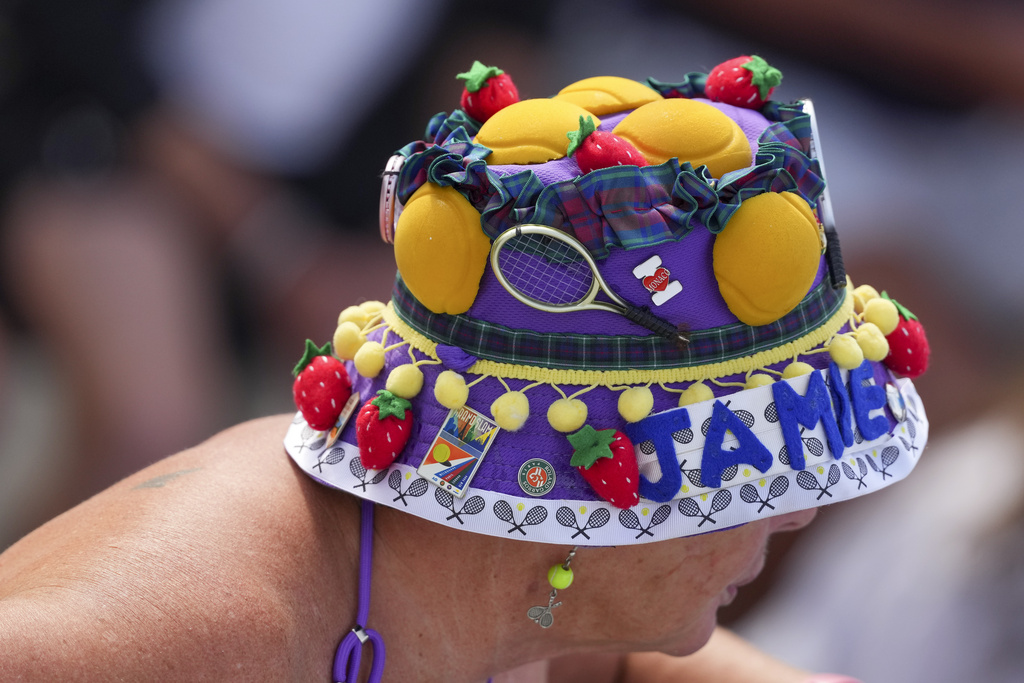 A spectator dons a colorful hat while watching play during the second round of the U.S. Open tennis championships, Thursday, Aug. 28, 2025, in New York. (AP Photo/Kirsty Wigglesworth)