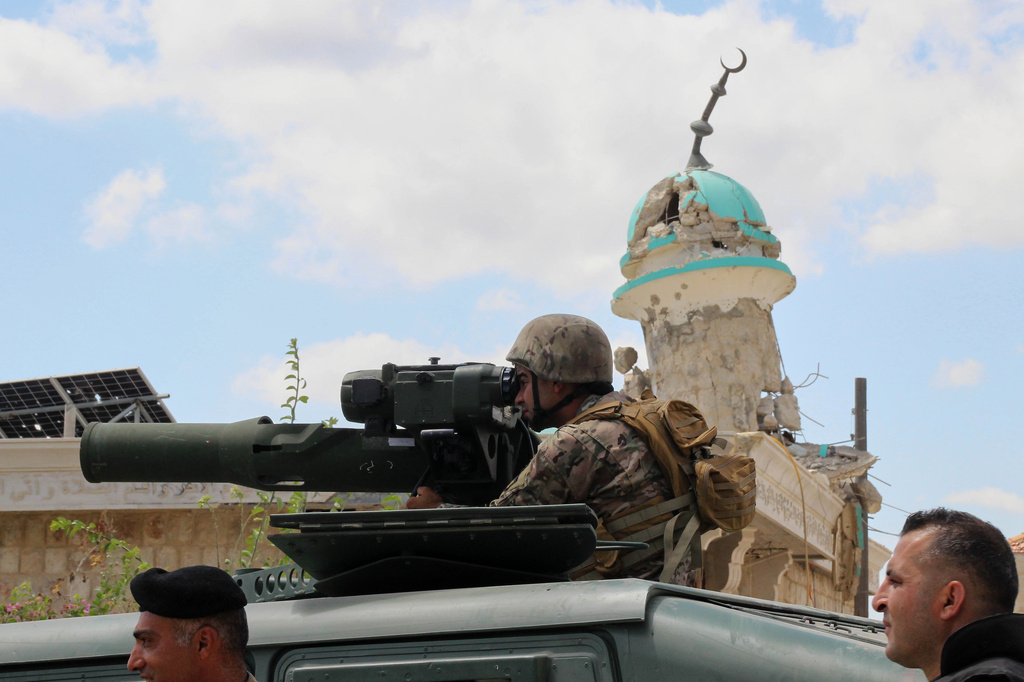 A Lebanese soldier looks through the binoculars of an anti-tank launcher in front of a destroyed mosque after deploying in the village of Zawtar al-Gharbiyeh, southern Lebanon, Sunday, July 26, 2026. (AP Photo/Ahmad Mantash)