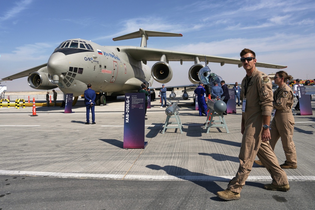 U.S. Air Force airmen walk past a Russian Ilyushin Il-76 transport plane at the Dubai Air Show in Dubai, United Arab Emirates, Monday, Nov. 17, 2025. (AP Photo/ Fatima Shbair)