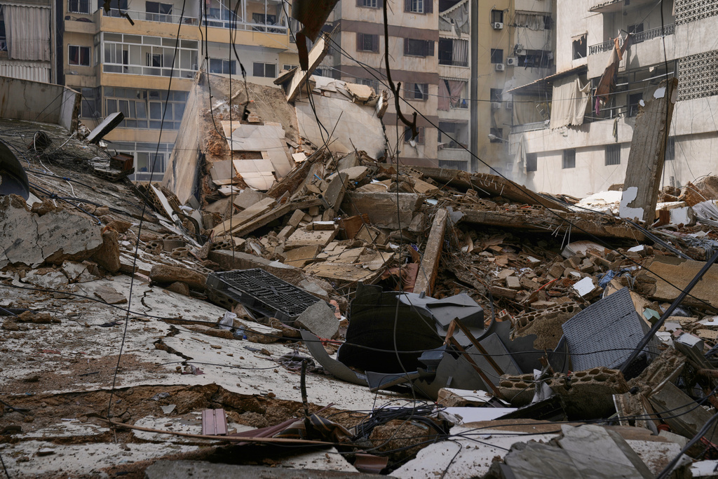 Debris litters a street from buildings damaged in an Israeli airstrike in Dahiyeh, Beirut's southern suburbs, Lebanon, Monday, March 16, 2026. (AP Photo/Bilal Hussein)