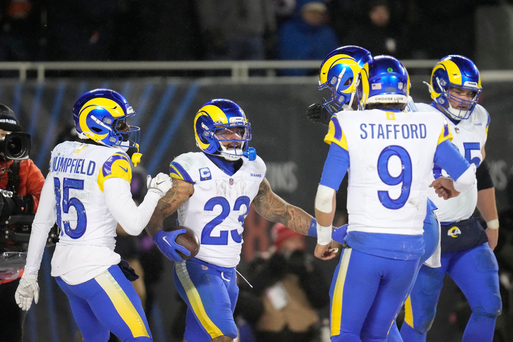 Los Angeles Rams running back Kyren Williams (23) celebrates his touchdown run with wide receiver Konata Mumpfield (15), quarterback Matthew Stafford (9), offensive tackle Warren McClendon Jr. back right, and center Coleman Shelton (65) during the second half of an NFL football divisional playoff game Sunday, Jan. 18, 2026, in Chicago. (AP Photo/Erin Hooley)