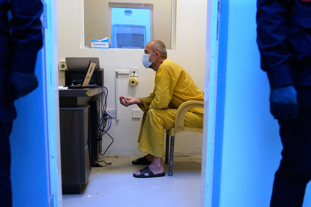A suspected Islamic State militant arrives for questioning, after he was transferred from Syria to Iraq, at Al-Karkh Central Prison in Baghdad, Iraq, Thursday, Feb. 12, 2026. (AP Photo/Hadi Mizban)