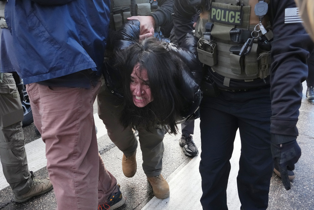 A protester is detained by Federal agents near the scene where Renee Good was fatally shot by an ICE officer last week, Tuesday, Jan. 13, 2026, in Minneapolis.(AP Photo/Adam Gray)(AP Photo/Adam Gray)