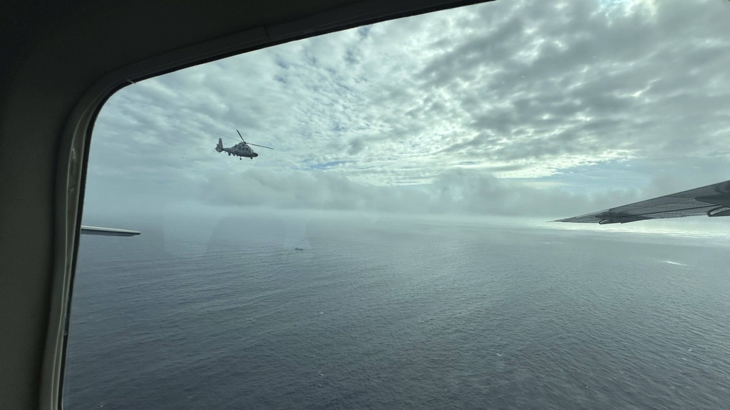 FILE - A Chinese military helicopter flies close to a Philippine Bureau of Fisheries and Aquatic (BFAR) aircraft above Scarborough shoal on Tuesday, Feb. 18, 2025. (AP Photo/Joeal Calupitan, File)