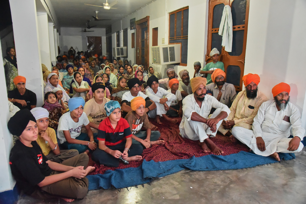 Villagers watch a special screening of the film “Satluj” at a Sikh temple at Tatley village, in Punjab's Gurdaspur district, India, Wednesday, July 8, 2026. (AP Photo/Prabhjot Gill)