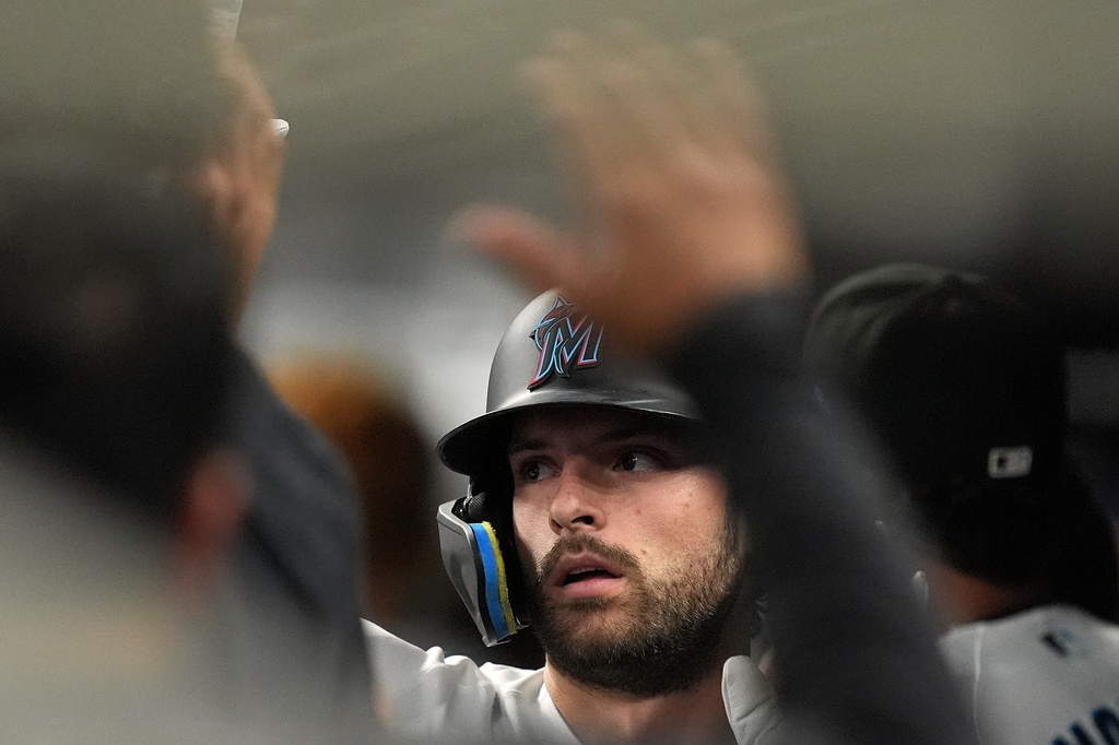 Miami Marlins' Joe Mack celebrates with teammates after grounding out to bring in a run by Jakob Marsee, during the second inning of a baseball game against the Atlanta Braves, Monday, May 18, 2026, in Miami. (AP Photo/Rebecca Blackwell)