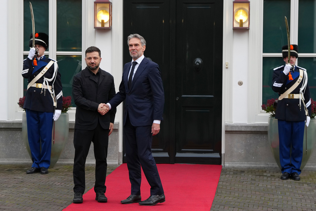 Dutch Prime Minister Dick Schoof, center, welcomes Ukraine's President Volodymyr Zelenskyy in The Hague, Netherlands, Tuesday, Dec. 16, 2025. (AP Photo/Peter Dejong)