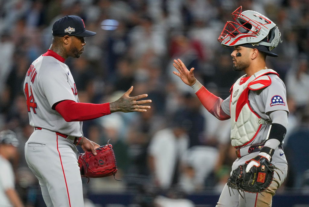 Boston Red Sox pitcher Aroldis Chapman, left, and catcher Carlos Narváez celebrate after defeating the New York Yankees in Game 1 of an American League wild-card baseball playoff series, Tuesday, Sept. 30, 2025, in New York. (AP Photo/Yuki Iwamura)