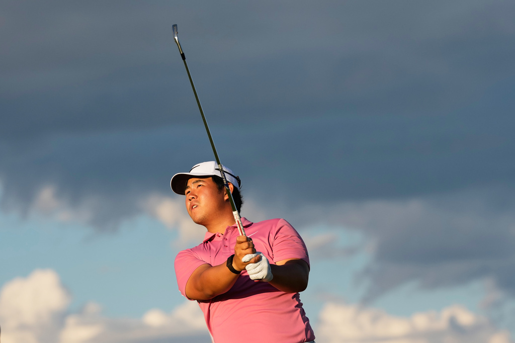 Tom Kim, of South Korea, watches his tee shot on the 17th hole during the third round of the U.S. Open golf tournament at Shinnecock Hills Golf Club in Southampton, N.Y., Saturday, June 20, 2026.(AP Photo/David J. Phillip)