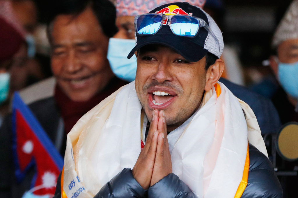 FILE - Nirmal Purja gestures at Tribhuwan International airport in Kathmandu, Nepal, Jan. 26, 2021. (AP Photo/Niranjan Shrestha, File)