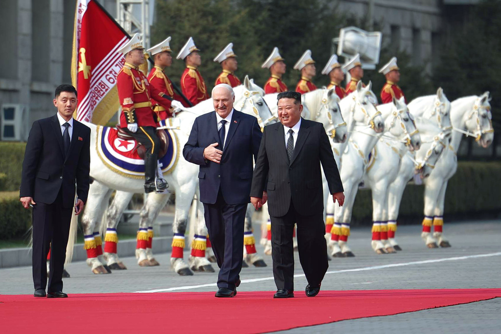 In this photo released by Belarus' Presidential Press Service, North Korea's leader Kim Jong Un, right, and Belarusian President Alexander Lukashenko, center, walk during official meeting ceremony in Pyongyang, North Korea, Wednesday, March 25, 2026. (Belarus' Presidential Press Service via AP)