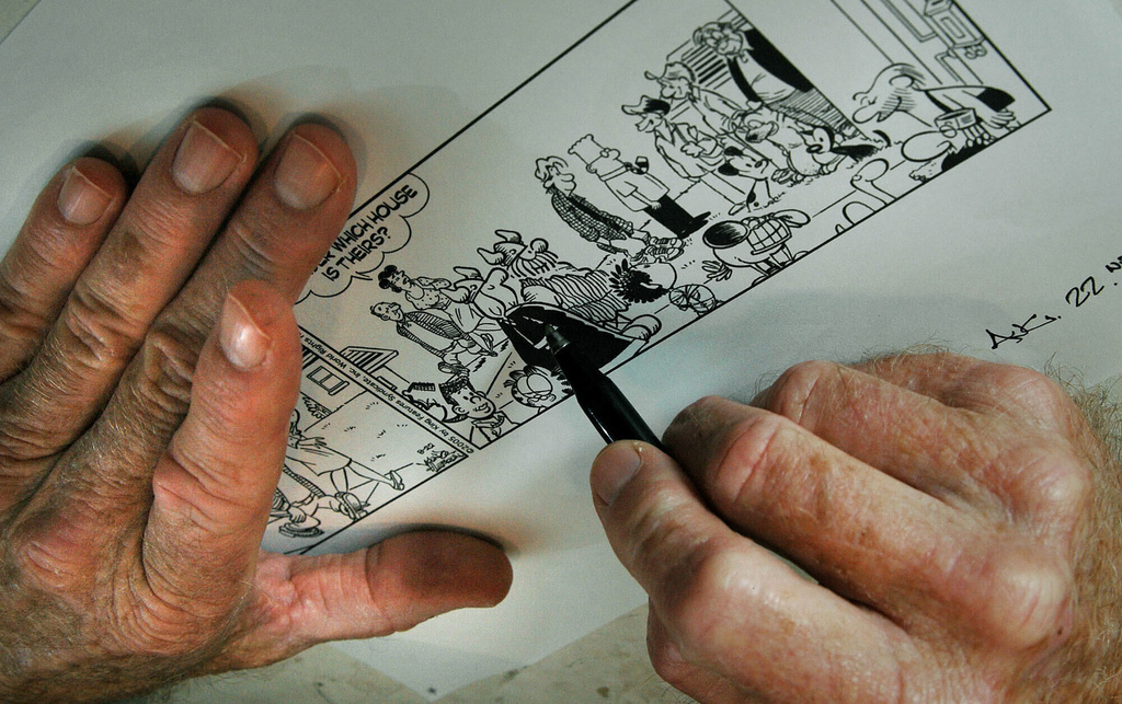 FILE - Dean Young, writer of the"Blondie" comic strip, draws in his studio in Clearwater, Fla., July 12, 2005. (AP Photo/Robert Azmitia, File)