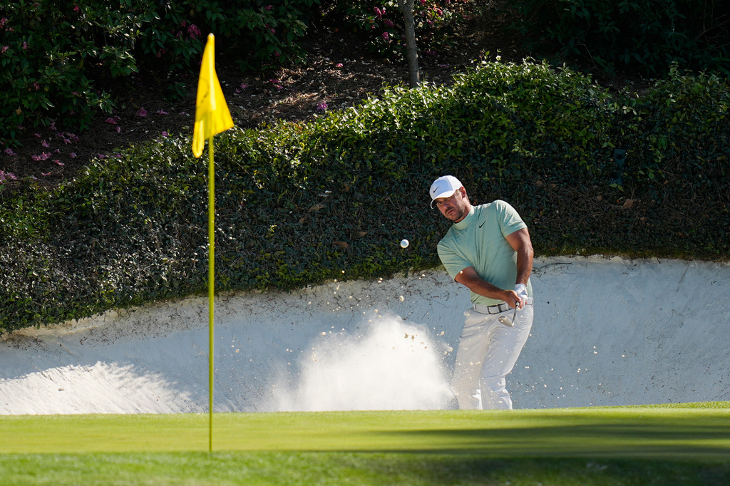 Brooks Koepka hits from the bunker on the 12th hole during the first round of the Masters golf tournament at the Augusta National Golf Club, Thursday, April 9, 2026, in Augusta, Ga. (AP Photo/Eric Gay)