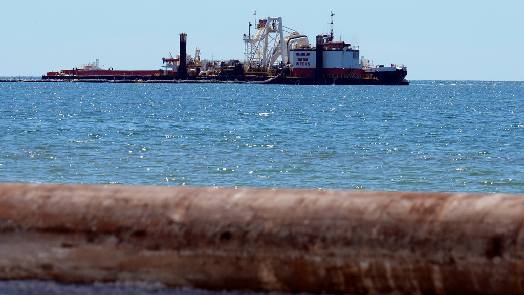 A dredge boat pumps sand back onto the beach along the gulf Thursday, Sept. 25, 2025, in Indian Rocks Beach, Fla. (AP Photo/Chris O'Meara)