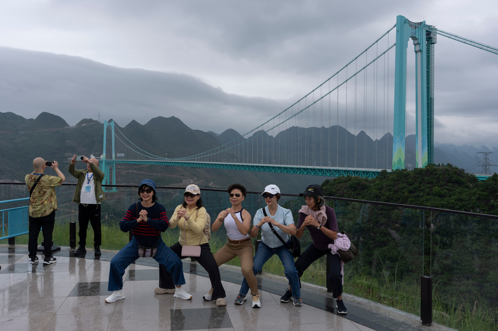 Tourists pose for photos near the Huajiang Grand Canyon Bridge, considered to be the world’s highest bridge, in Anshun in southwestern China's Guizhou province on Friday, May 29, 2026. (AP Photo/Ng Han Guan)
