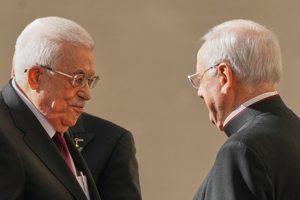 Palestinian President Mahmoud Abbas, also known as Abu Mazen, left, is welcomed by Monsignor Leonardo Sapienza as he arrives in the St. Damasus Courtyard at the Vatican for a meeting with Pope Leo XIV, Thursday, Nov. 6, 2025. (AP Photo/Andrew Medichini)