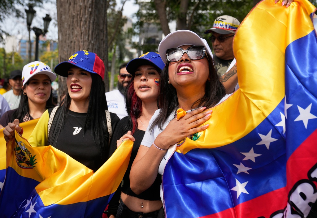 Venezuelans celebrate after President Donald Trump announced that President Nicolas Maduro had been captured and flown out of Venezuela, in Lima, Peru, Saturday, Jan. 3, 2026. (AP Photo/Martin Mejia)