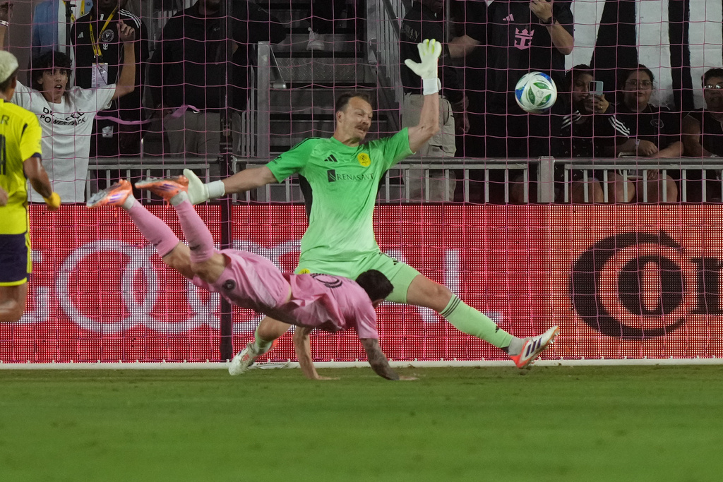 Inter Miami forward Lionel Messi (10) scores a goal against Nashville SC goalkeeper Joe Willis (1) during the first half of match one of an MLS playoff opening round soccer match Friday,, Oct. 24, 2025, in Fort Lauderdale, Fla. (AP Photo/Marta Lavandier)