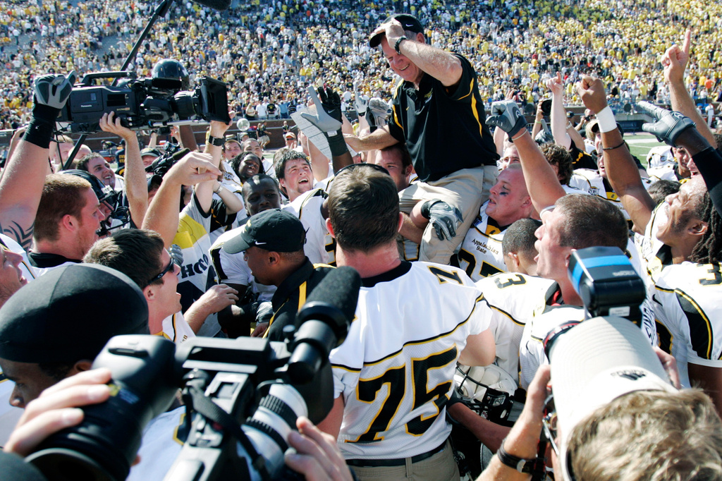 FILE - Appalachian State coach Jerry Moore is carried off the field by his players at Michigan Stadium after they upset Michigan in an NCAA college football game Sept. 1, 2007, in Ann Arbor, Mich. (AP Photo/Duane Burleson, File)