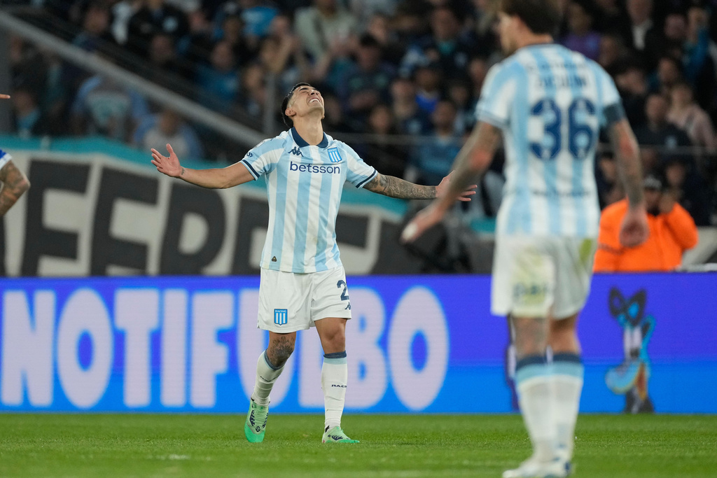 Santiago Solari of Argentina's Racing Club celebrates scoring his side's opening goal against Argentina's Velez Sarsfield during a Copa Libertadores quarterfinal second leg soccer match at Presidente Peron stadium in Avellaneda, Argentina, Tuesday, Sept. 23, 2025. (AP Photo/Gustavo Garello)