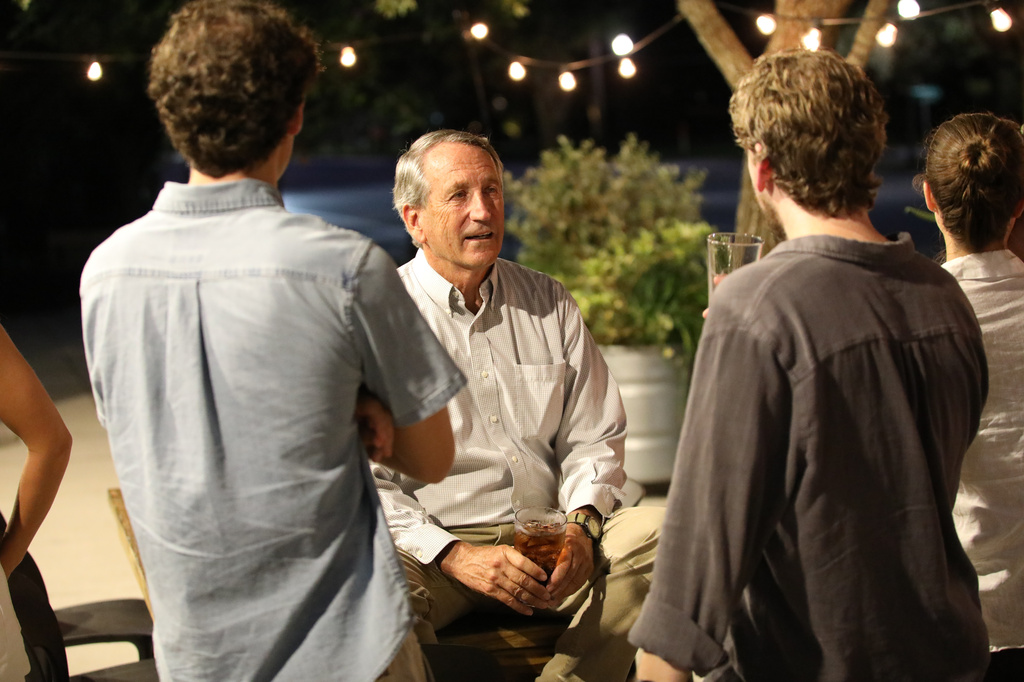 Former South Carolina Gov. Mark Sanford enjoys a beer and talks to his son during his election party on Tuesday, Aug. 11, 2026, in Mount Pleasant, S.C. (AP Photo/Jeffrey Collins)
