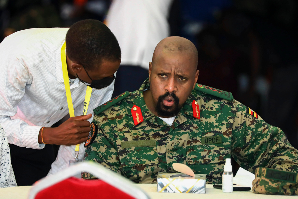 FILE - Then Lt. Gen. Muhoozi Kainerugaba, right, son of Uganda's President Yoweri Museveni, speaks to Attorney General Kiryowa Kiwanuka, left, at a "thanksgiving" ceremony in Entebbe, Uganda, on May 7, 2022. (AP Photo/Hajarah Nalwadda, File)