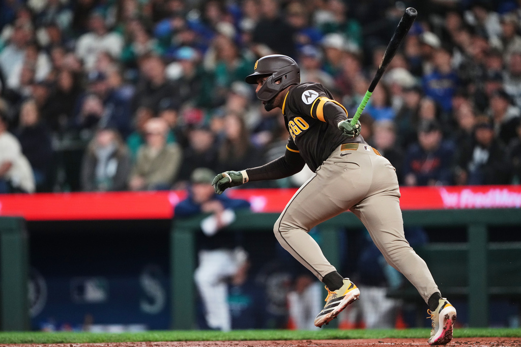 San Diego Padres' Miguel Andujar hits an RBI double against the Seattle Mariners during the fourth inning of a baseball game, Friday, May 15, 2026, in Seattle. (AP Photo/Lindsey Wasson)