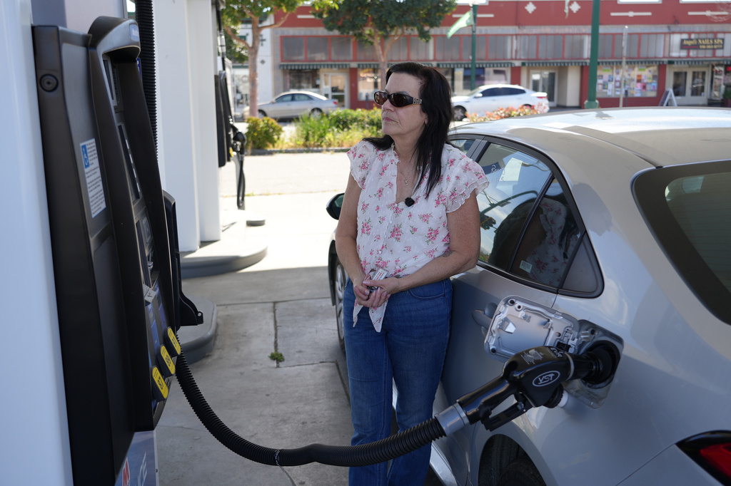 Leslie Sherman-Shafer, an Uber driver, fills up her car at a gas station in Alameda, Calif, March 23, 2026. (AP Photo/Terry Chea)