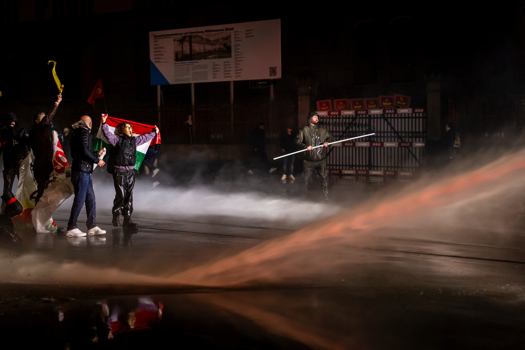 Protesters clash with riot police using water cannons and tear gas after a rally against the World Economic Forum in Davos and the visit of US President Donald Trump, on Monday, in Zurich, Switzerland, Jan. 19, 2026. (Michael Buholzer/Keystone via AP)