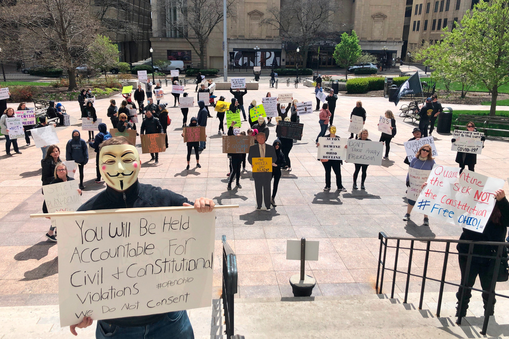 People protest outside the Ohio Statehouse on April 9, 2020, in Columbus, Ohio, on the state's shutdown of the economy, and to question the models used by Health Director Dr. Amy Acton to continue her shelter-at-home order during the pandemic. (AP Photo/Andrew Welsh-Huggins, File)