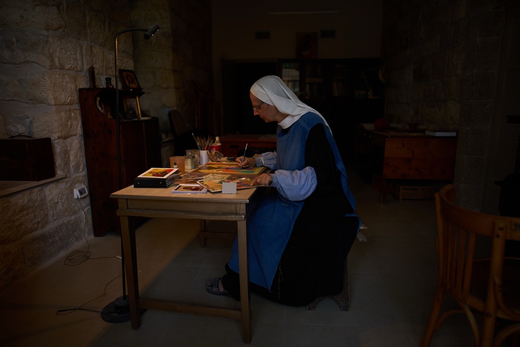 Sister Marie Benedicte, a Catholic nun, writes an icon in the Benedictine monastery on top of the Mount of Olives in Jerusalem, Friday, Oct. 17, 2025. (AP Photo/Oded Balilty)