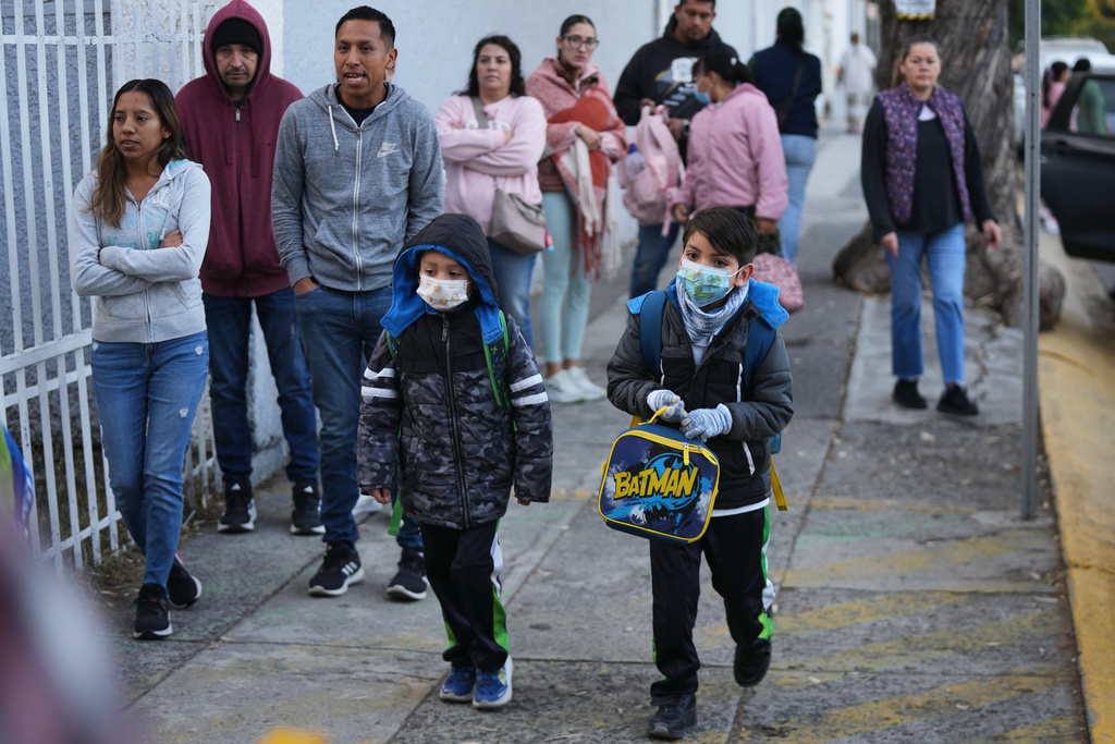 Students arrive to school wearing face masks due to a measles outbreak in Guadalajara, Mexico, Friday, Feb. 6, 2026. (AP Photo/Fernando Llano)